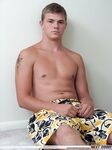 Shy brunette twink Phil strips and wanks his rod while
